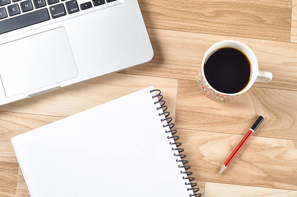 istock Top view of office desk with laptop, blank white page 626752286