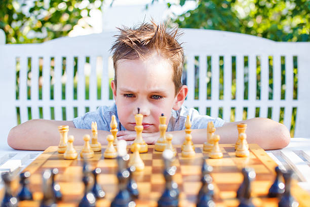 istock stressful child at the chessboard 626752588