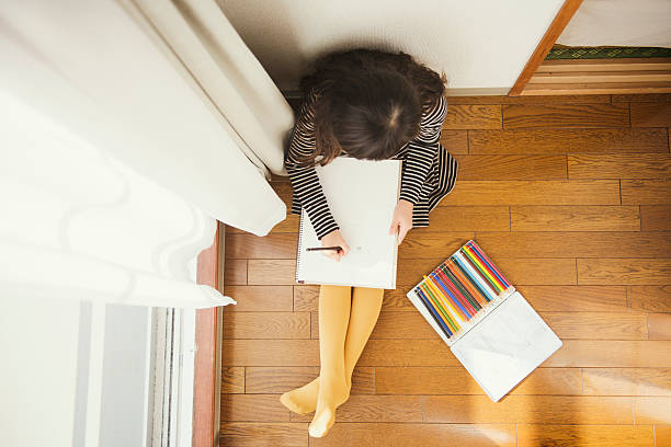 istock Girl drawing and playing in house 626753526