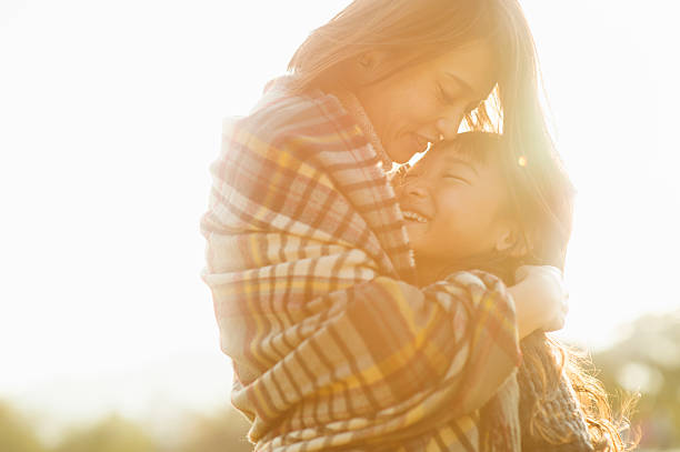 istock Mother hugging daughter in outdoors 626754540