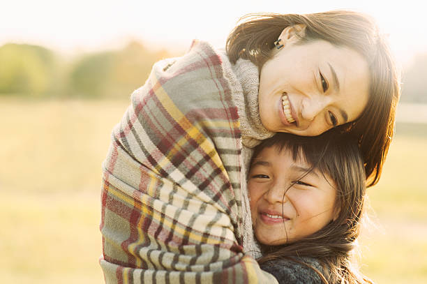istock Mother hugging daughter in outdoors 626754636