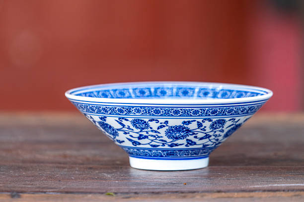 istock blue and white porcelain bowl on wooden table 626755476