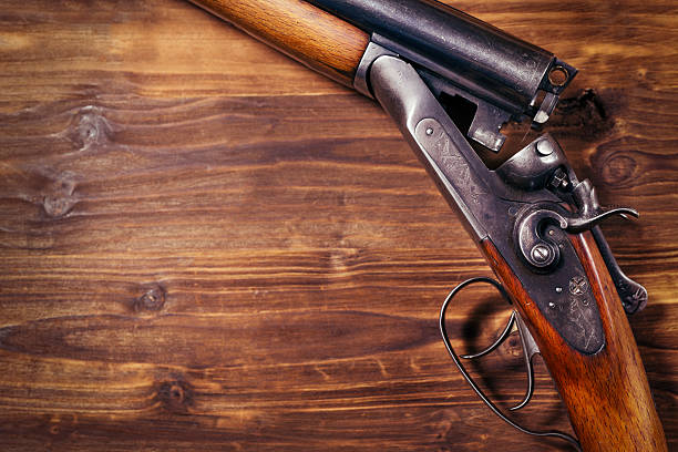 istock Shotgun on wooden background 626771134