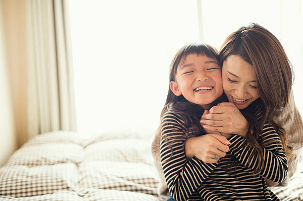 mother and daughter playing in bed room - 八歲到九歲 個照片及圖片檔