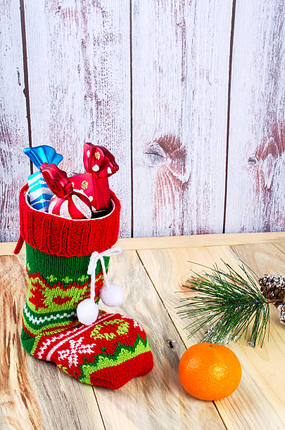 istock On the table is a colorful Christmas sock with candies. 626774650
