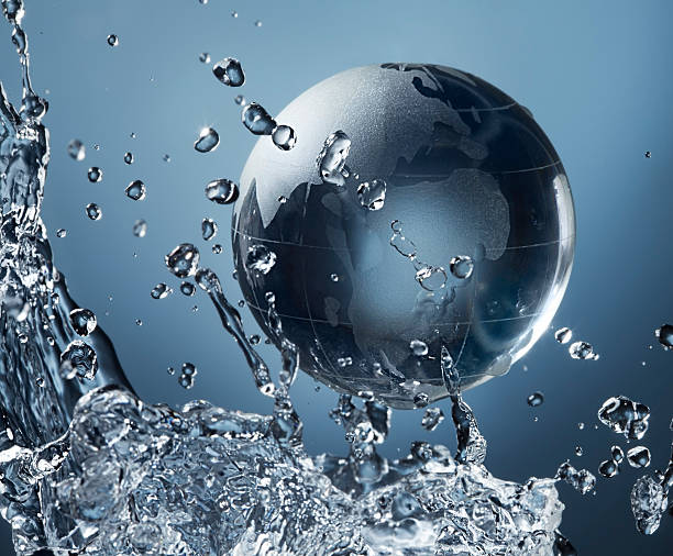 istock glass globe planet in drop water splash on blue background 626774686