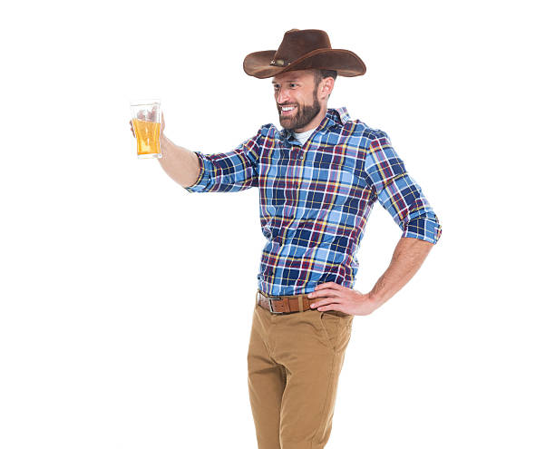 istock Smiling cowboy holding drink glass 626777114