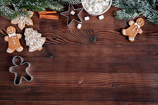 istock Christmas gingerbread, spruce branches on dark wooden background top view 626777300