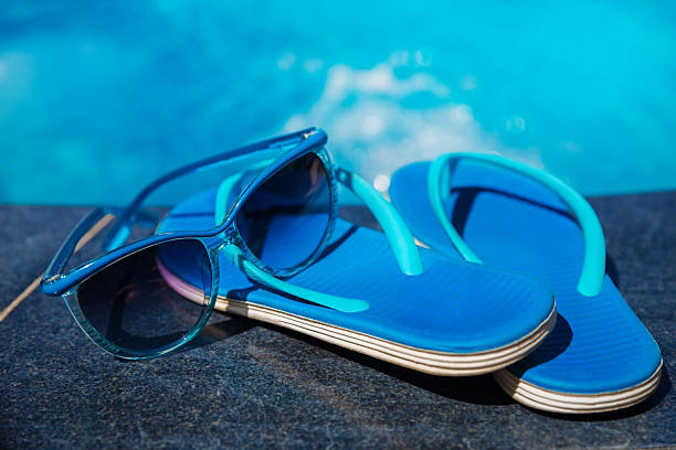istock slippers and sunglasses on swimming pool 626777842