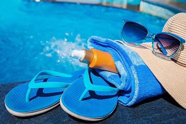 istock slippers sunscreen cream towel hat sunglasses 626778100