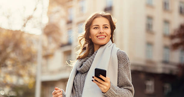 istock Young woman texting outdoors 626778886