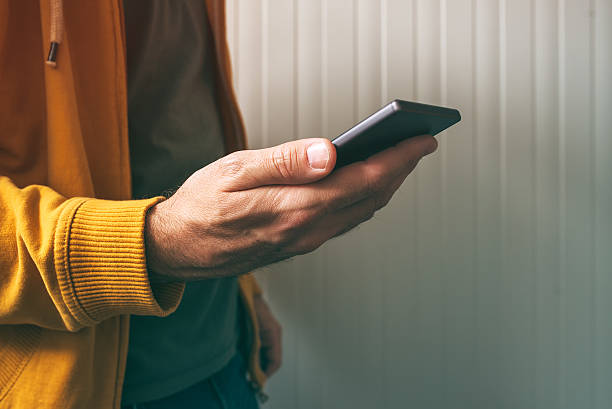 Casual young adult man using mobile phone