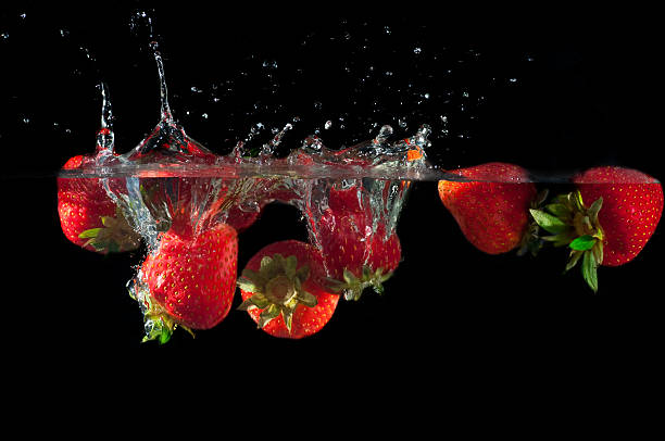 istock Strawberries splashing into water 626783086