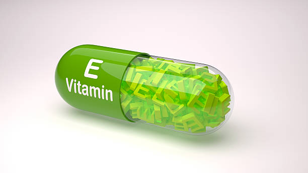 Green pill or capsule filled with vitamin E.