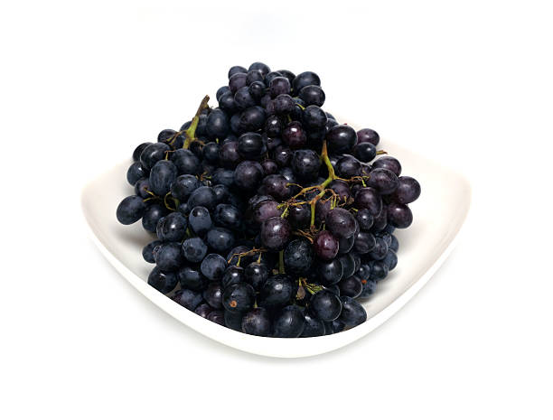 istock Ripe grape bunches in white bowl isolated 626785282