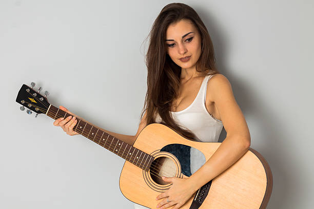 istock young brunette woman with guitar 626786246