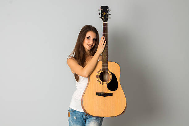 istock cutie woman with guitar in hands 626786472
