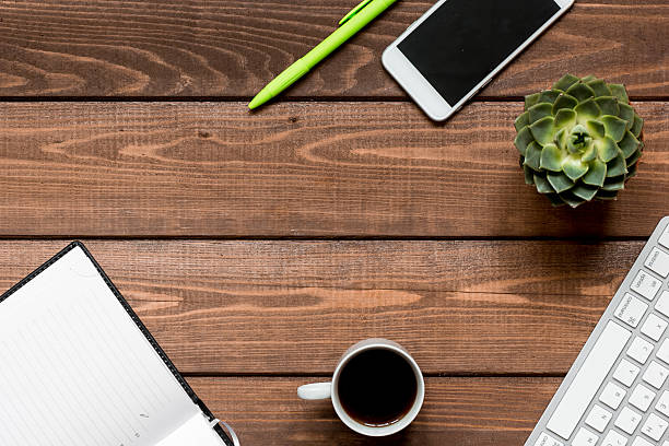 istock male work desktop wooden top view 626786916