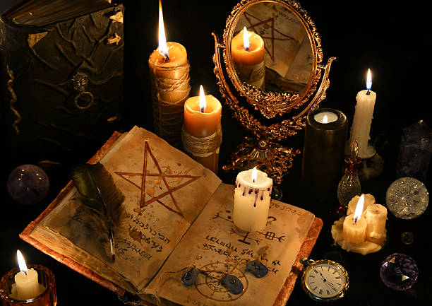 istock Magic still life with books, burning candles and mirrow 626787986