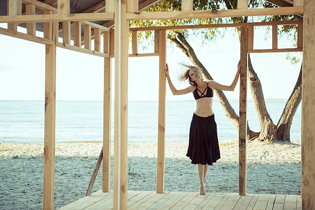 istock Young beautiful girl dancing on the beach. Summer. Dynamic. Cont 626788368