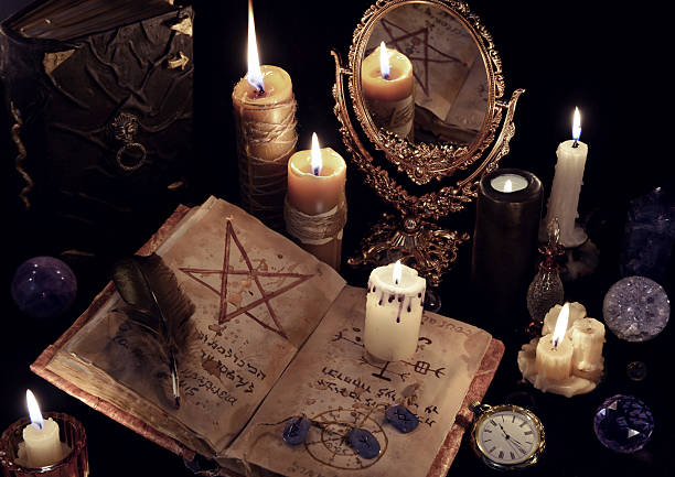 istock Magic still life with books, burning candles and mirrow 626789556