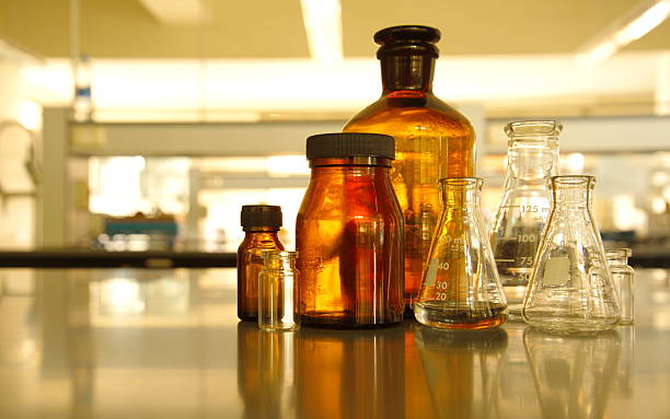istock glass flask and retro brown bottle reagent in lab science 626790506