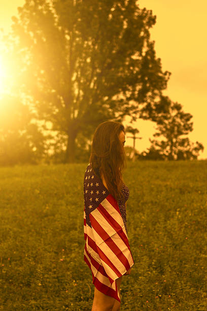 istock young woman with an American flag 626791118