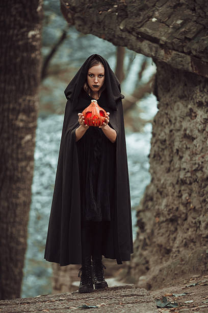 istock Wicked witch with a Halloween pumpkin 626791162