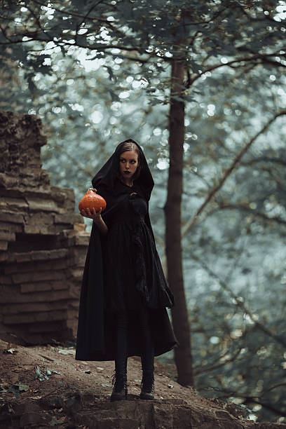 istock Wicked witch with a Halloween pumpkin 626791484