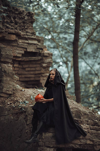 istock Wicked witch with a Halloween pumpkin 626791602