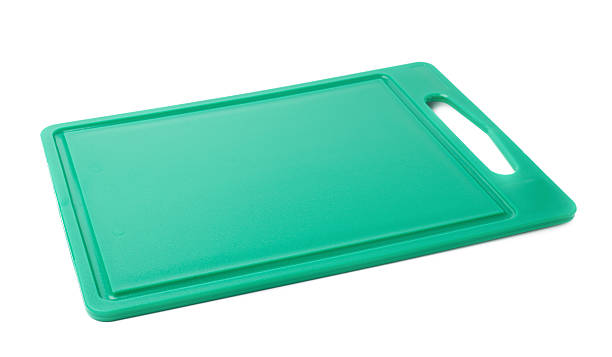 istock Unused plastic green cutting board isolated over the white background 626791660
