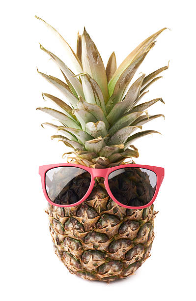 istock Whole pineapple with sunglasses isolated over white background 626799658