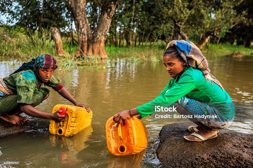 African women are taking water from the river, Ethiopia, Africa African women are taking water from the river, African women and children often walk long distances to bring back jugs of water that they carry on their back.http://bhphoto.pl/IS/ethiopia_380.jpg Africa Stock Photo