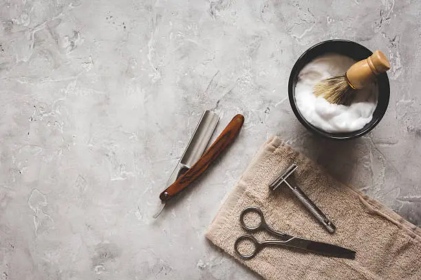 Photo of Mens hairdressing desktop with tools for shaving top view