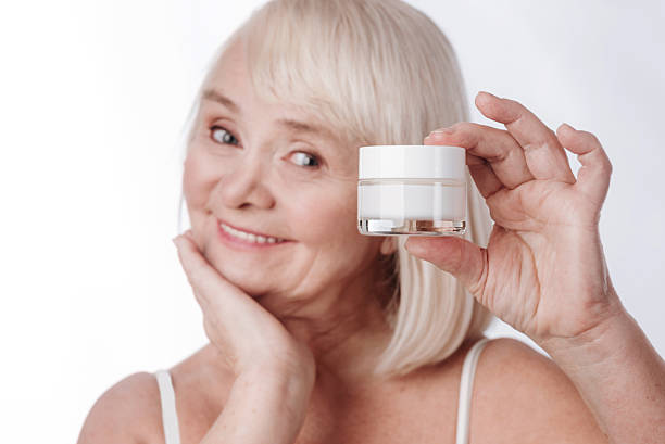istock Cheerful pleasant woman holding a cream bottle 626810652