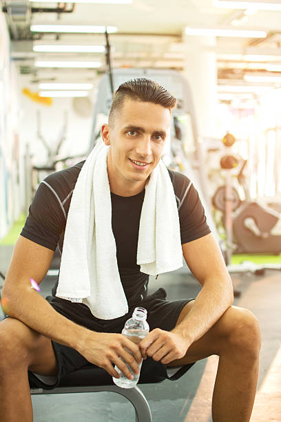 istock Handsome man having a break after workout in gym. 626811006