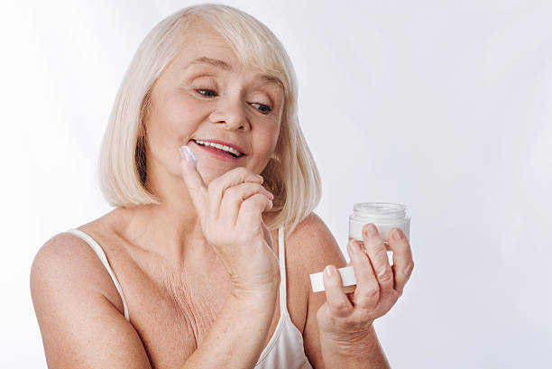 istock Nice good looking woman putting anti age cream 626811062