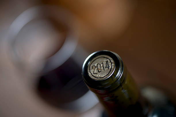 istock Close-up of closed wine bottles lying on blurry background 626811466
