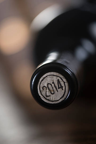 istock Close-up of closed wine bottles lying on blurry background 626811938