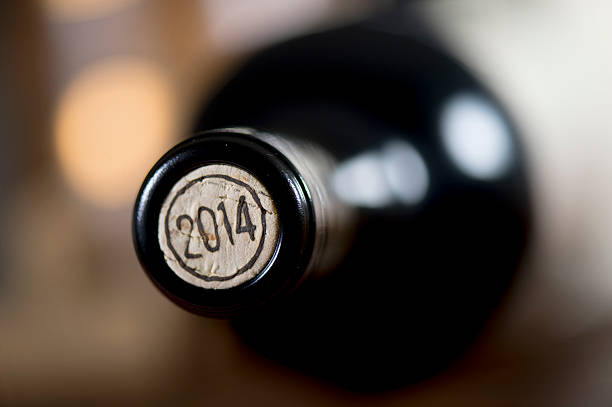 istock Close-up of closed wine bottles lying on blurry background 626812572