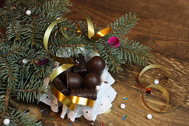 istock Chocolate candy near Christmas tree 626812952