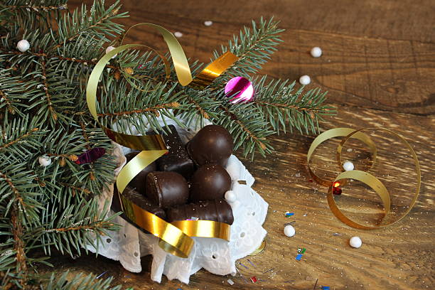 istock Chocolate candy near Christmas tree 626813098