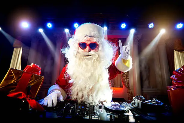 Photo of Dj Santa Claus mixing at the party Christmas