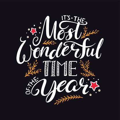 the most wonderful time of the year. hand written christmas lettering on black background