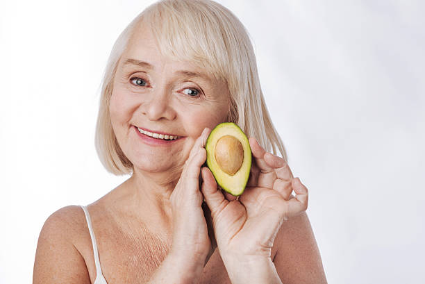 istock Delighted senior woman holding an avocado 626815546