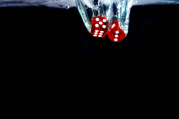 istock Red dice fall into the water. Casino concept 626815792