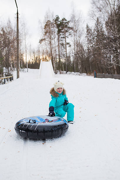 istock happy girl riding on a sled   mountain high 626817026