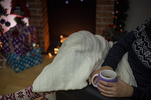 istock Woman having a drink by a fireplace 626817278