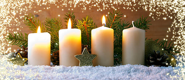 istock Three burning advent candles and luminous lights. 626823264