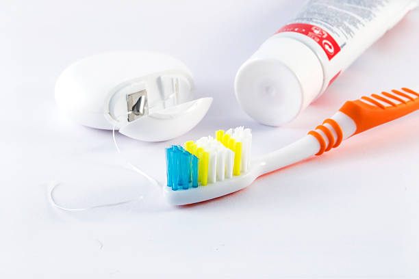 istock Toothbrush, dental floss and toothpaste on white background 626823712
